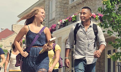students walking around campus on a sunny day 
